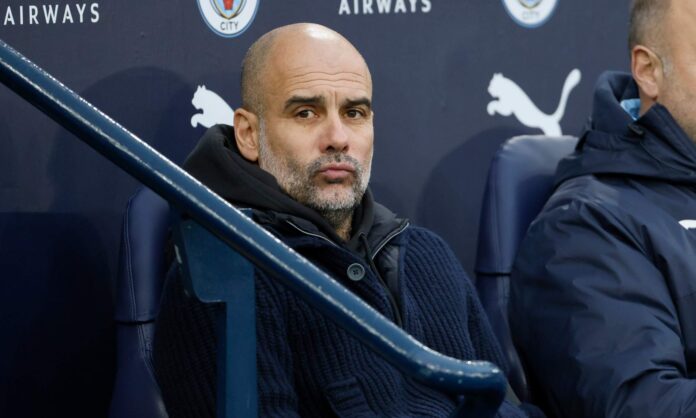 Pep Guardiola, sentado en el banquillo del Etihad durante un partido del Manchester City.